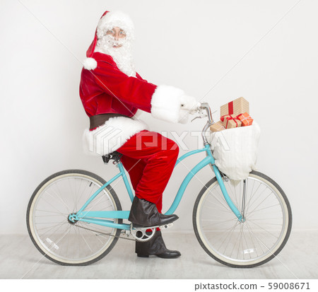 Crazy Santa riding a bike with Christmas presents Crazy Santa riding a bike with Christmas presents 59008671