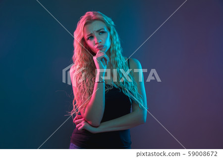 Caucasian young woman's portrait on gradient background in neon light Caucasian young woman's portrait on gradient background in neon light 59008672