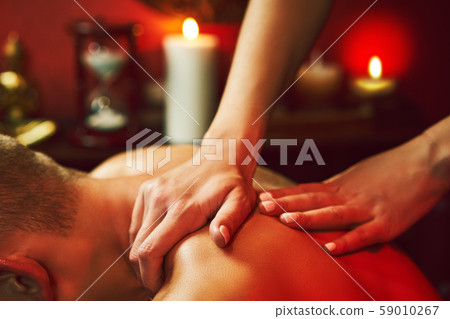 Masseur doing neck massage on man in the spa salon. Masseur doing neck massage on man in the spa salon. 59010267