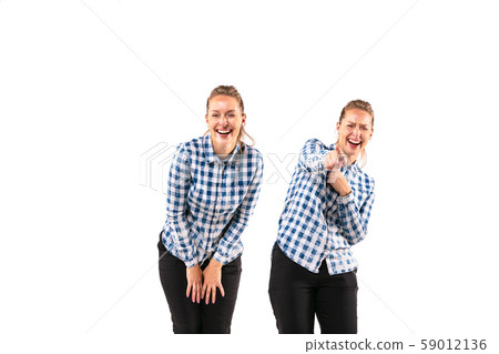 Young handsome woman arguing with herself on white studio background. 59012136