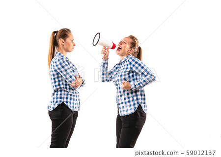 Young handsome woman arguing with herself on white studio background. 59012137