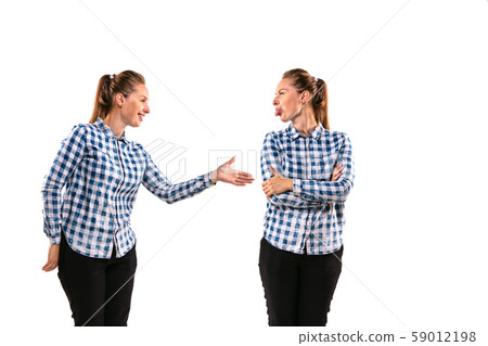 Young handsome woman arguing with herself on white studio background. 59012198