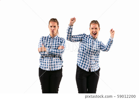 Young handsome woman arguing with herself on white studio background. Young handsome woman arguing with herself on white studio background. 59012200