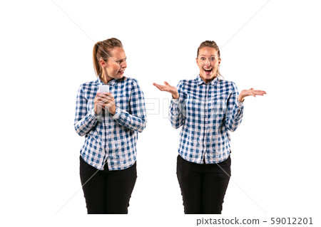 Young handsome woman arguing with herself on white studio background. Young handsome woman arguing with herself on white studio background. 59012201