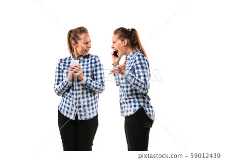 Young handsome woman arguing with herself on white studio background. 59012439