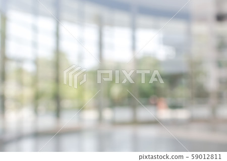 Blur background interior view looking out toward to empty office lobby and entrance doors and glass curtain wall Blur background interior view looking out toward to empty office lobby and entrance doors and glass curtain wall 59012811