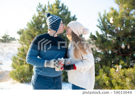 The guy with the girl walk and kiss in the winter 59013049