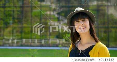 portrait of young brunette girl with summer hat in 59013438