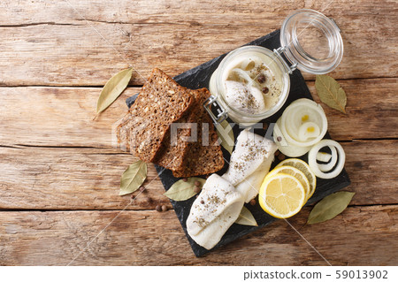 Baltic pickled herring with onions in a glass jar 59013902