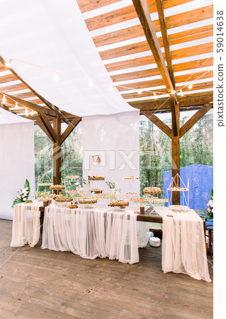 Wedding stand-up meal. Snack for guests. Celebration. Wedding buffet in restaurant outdoors, wooden 59014638