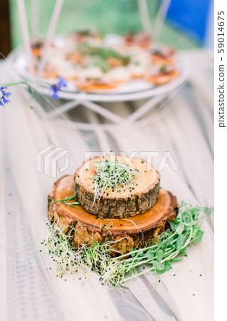 Fresh micro greens on wooden stands plates on the table. Catering service. Restaurant table with 59014675