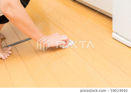 Woman brushing the floor 59014692