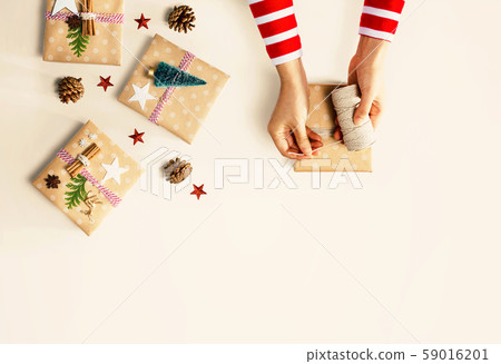 Person making Christmas gift boxes Person making Christmas gift boxes 59016201