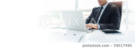 Concentrated Businessman is working on Laptop Concentrated Businessman is working on Laptop 59017490