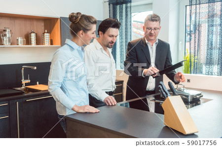 Couple checking out new kitchen in the store 59017756