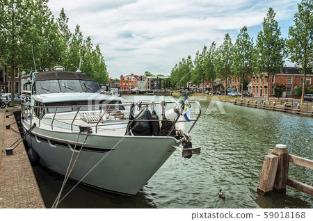 Boat moored on wide canal in the city center of Weesp Boat moored on wide canal in the city center of Weesp 59018168