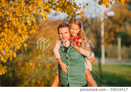 Family of dad and kid on beautiful autumn day in the park 59018417