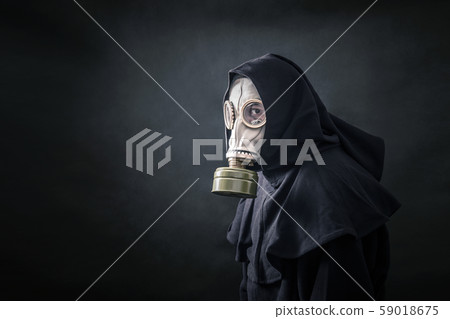Man in a gas mask and hooded cloak. Environment pollution. Man in a gas mask and hooded cloak. Environment pollution. 59018675