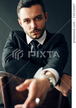 Handsome confident man portrait on dark background Handsome confident man portrait on dark background 59018887