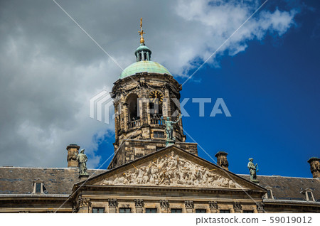 Facade with dome and golden clock in the Royal Palace of Amsterdam 59019012