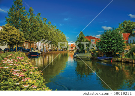 Canal with brick houses and moored boats at Weesp 59019231