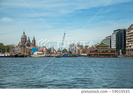 Port with ships, church towers and pagoda building in Amsterdam Port with ships, church towers and pagoda building in Amsterdam 59019585