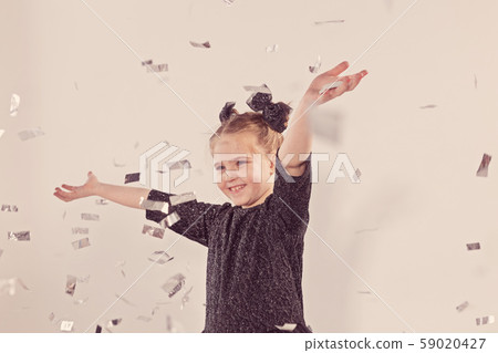 Party, holidays, new year and celebration concept - Female child throwing confetti. 59020427