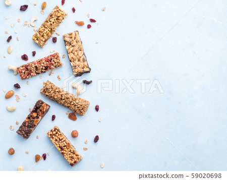 Set of different granola bars on blue background Set of different granola bars on blue background 59020698
