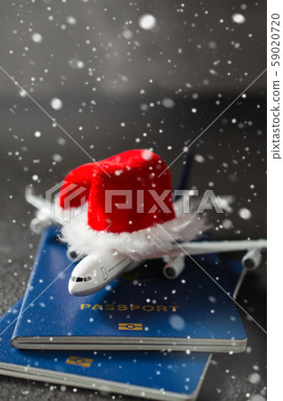 Christmas travel planning. Toy airplane with Santa Claus hat  59020720