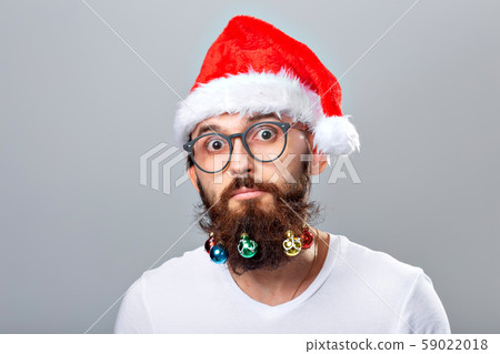 Christmas, holidays, barbershop and style concept - young handsome bearded santa claus man with many 59022018