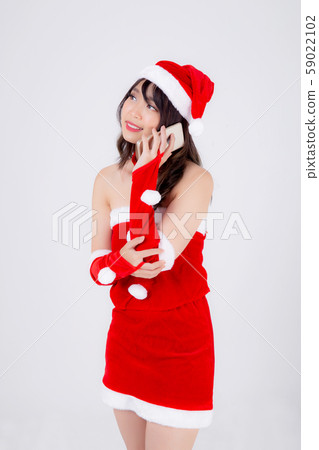 Beautiful portrait young asian woman in Santa talking smartphone in xmas day isolated Beautiful portrait young asian woman in Santa talking smartphone in xmas day isolated 59022102