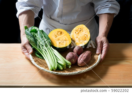 In front of a board with a vegetable bowl In front of a board with a vegetable bowl 59022202