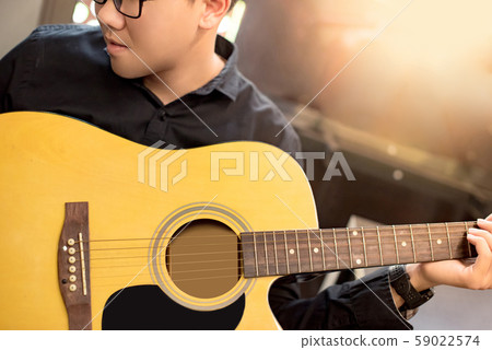 Asian man guitarist playing music with guitar 59022574