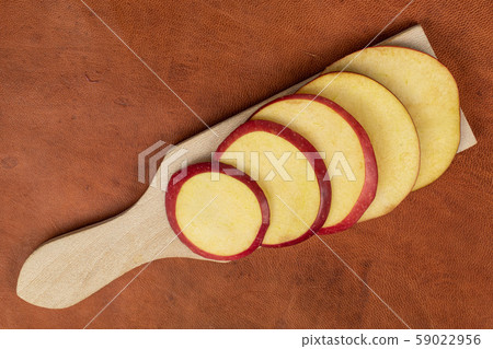 Red delicious apple on cognac leather Red delicious apple on cognac leather 59022956