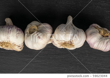 White aromatic garlic on grey stone White aromatic garlic on grey stone 59023044