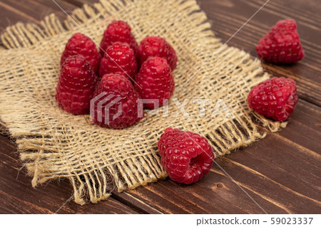 Fresh red raspberry on brown wood 59023337