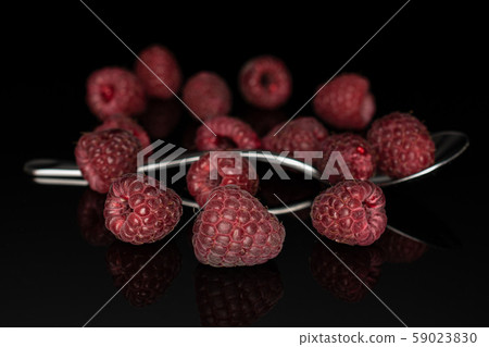 Fresh crimson raspberry isolated on black glass Fresh crimson raspberry isolated on black glass 59023830