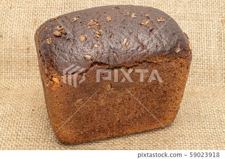 Fresh baked dark bread on jute Fresh baked dark bread on jute 59023918