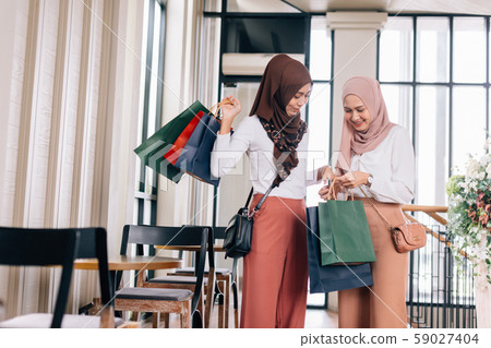 Cheerful Muslim friends during shopping Cheerful Muslim friends during shopping 59027404