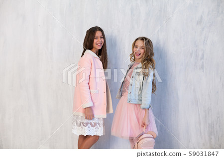 Portrait of two fashionable schoolgirl girls girlfriend in pink clothes Portrait of two fashionable schoolgirl girls girlfriend in pink clothes 59031847