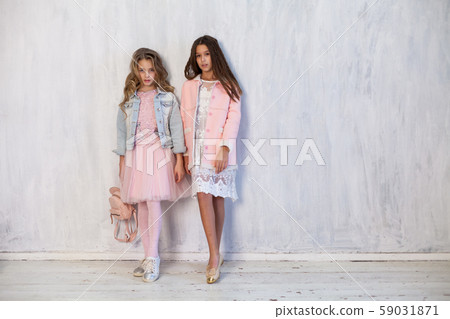 Portrait of two fashionable schoolgirl girls girlfriend in pink clothes Portrait of two fashionable schoolgirl girls girlfriend in pink clothes 59031871