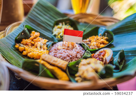 Nasi lemak, Nasi campur, Indonesian Balinese rice with potato fritter, sate lilit, fried tofu, spicy Nasi lemak, Nasi campur, Indonesian Balinese rice with potato fritter, sate lilit, fried tofu, spicy 59034237