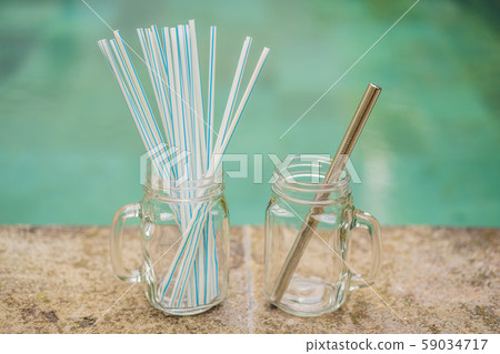 Steel drinking vs disposable straws on pool background. Zero waste concept 59034717