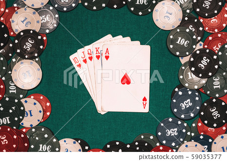 Royal flush on the background of gaming chips on the green table Royal flush on the background of gaming chips on the green table 59035377