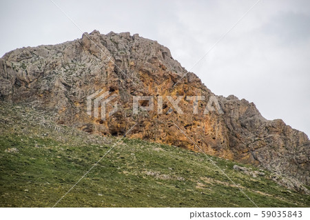 Caves in the limestone mountains. Void in rock Caves in the limestone mountains. Void in rock 59035843