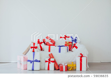 white sofa with gifts in the interior of the white room white sofa with gifts in the interior of the white room 59036635