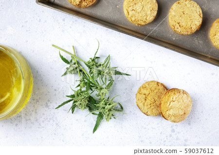 Cannabis butter cookies with marijuana buds and cannaoil, homemade healthy biscuits, shot from the Cannabis butter cookies with marijuana buds and cannaoil, homemade healthy biscuits, shot from the 59037612