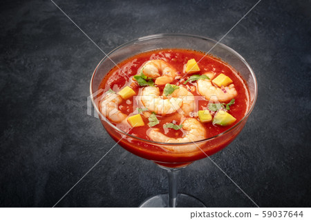 Coctel de gambas, Mexican shrimp cocktail with avocado, close-up on a black background 59037644