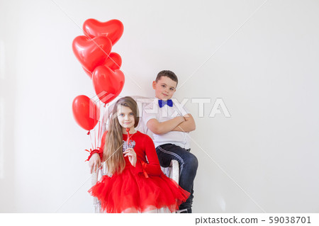 Kids with red balloons for birthday in the interior of the white room Kids with red balloons for birthday in the interior of the white room 59038701