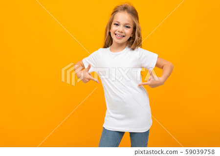 charming schoolgirl on an orange background in a white T-shirt gestures at herself 59039758
